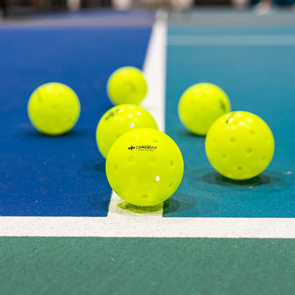 Diadem pickleballs on a blue court